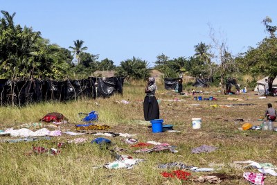 A woman stands in field where clothes are dried after washing in Metuge, Cabo Delgado Province. Make shift displace person camps have formed after a series of attacks has forced thousands to flee the north region.