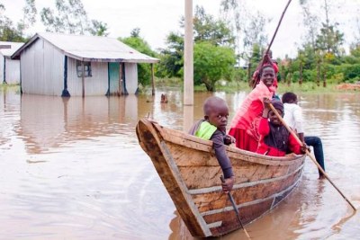 Children use a boat in the flooded Kakola Ombaka village on May 12, 2021 (file photo).