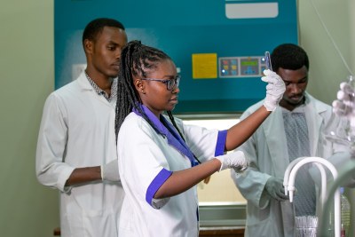 Aline Agasaro Makuza (centre) conducting an experiment with her peers in the microbiology lab at the College of Science and Technology, University of Rwanda, Nyarugenge Campus, Kigali City.